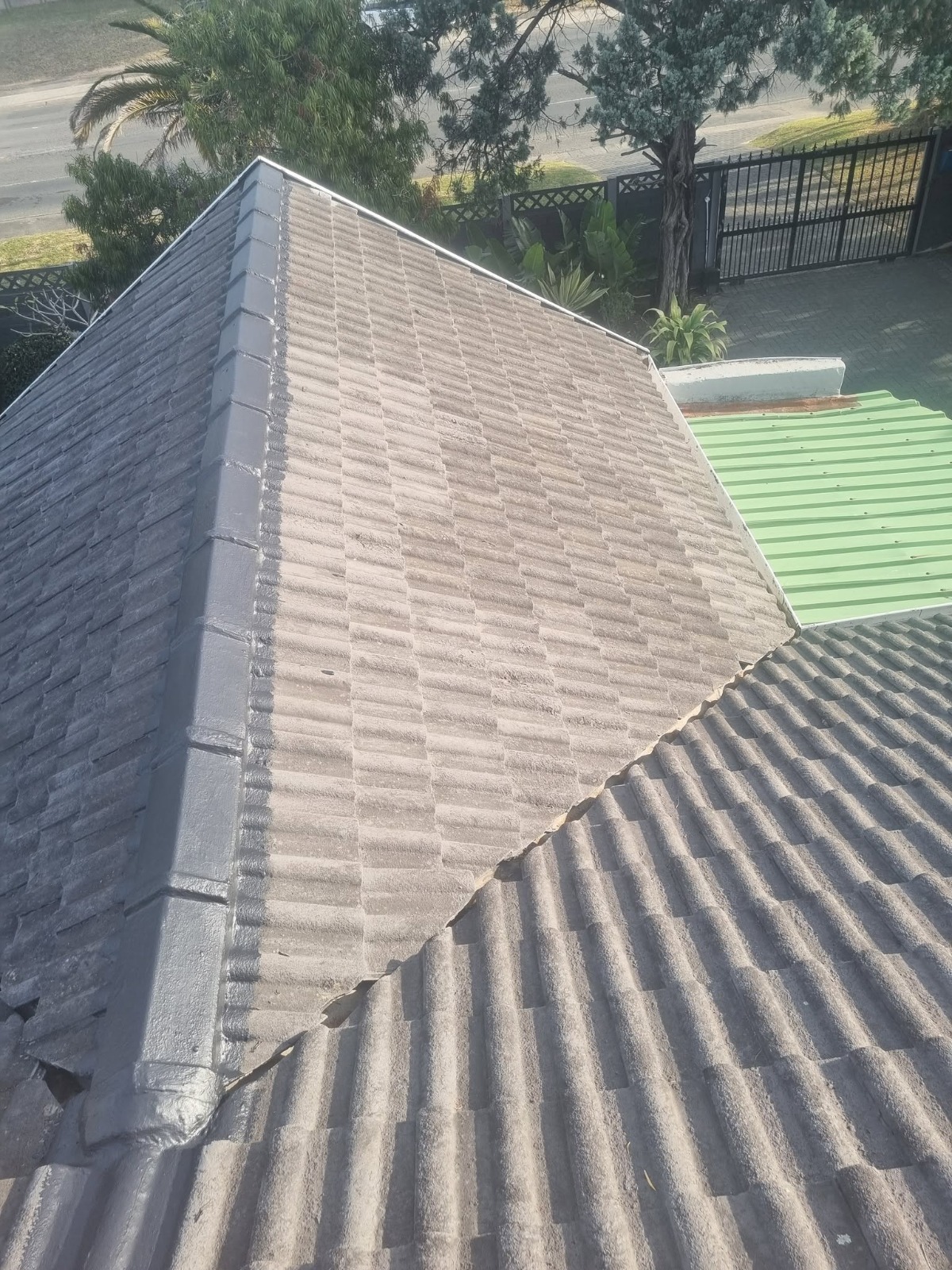 Before photo of old tiled roof ridge and vulnerable roof joint before waterproofing