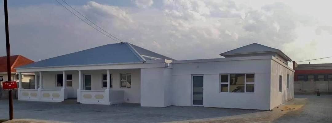 After re-roofing photo showing completed roof and restored property exterior