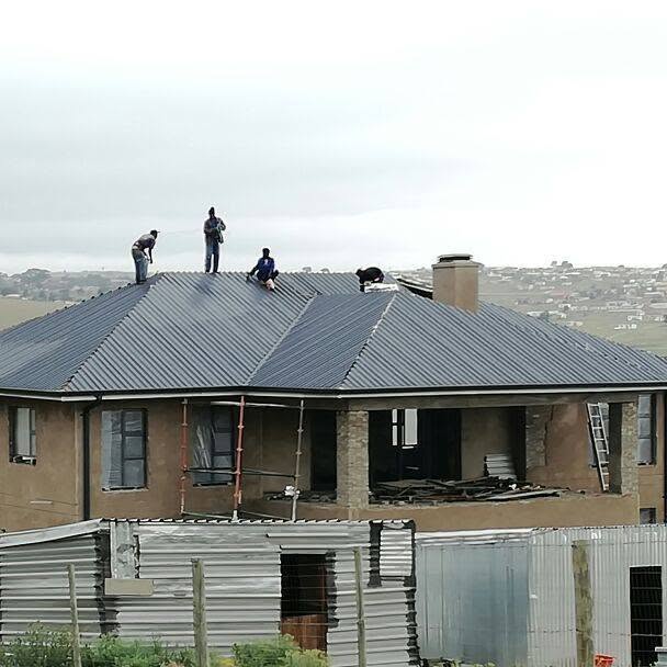 Roofing contractors working on a roof replacement project